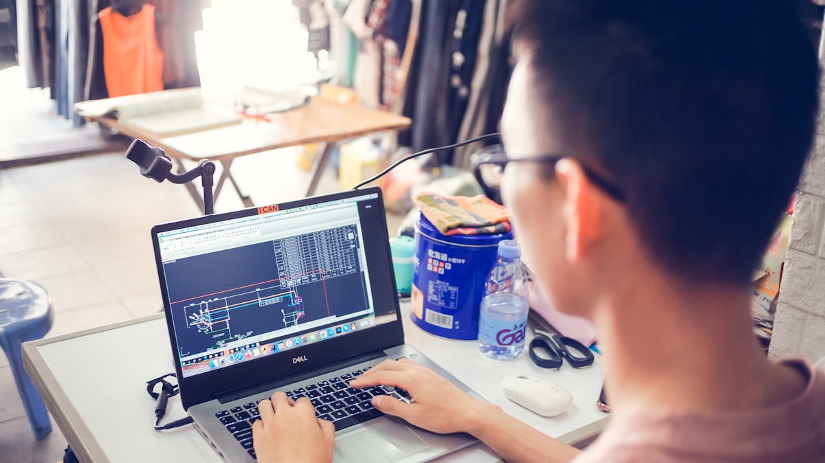 Fashion designer working at laptop studio
